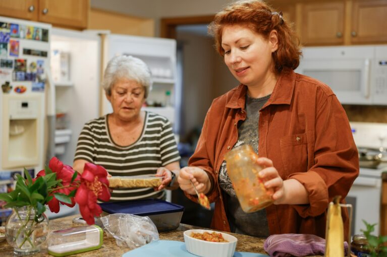 Two women preparing food in a kitchen, reflecting on being a narcissist